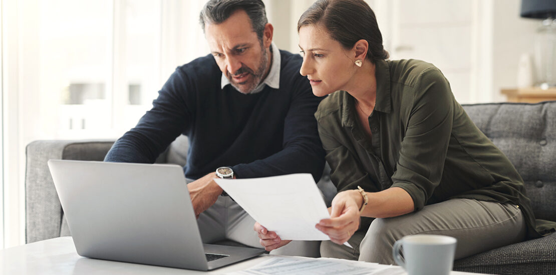 Retirement contribution planning with laptop and notebook