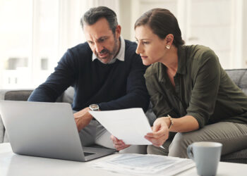 Retirement contribution planning with laptop and notebook