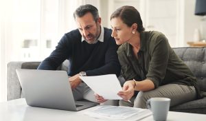 Retirement contribution planning with laptop and notebook