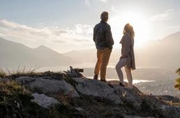 Middle-aged couple hiking together on a summer trail