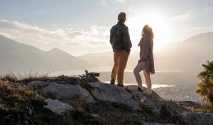 Middle-aged couple hiking together on a summer trail