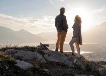 Middle-aged couple hiking together on a summer trail