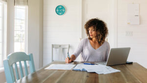 Social Security COLA update planning with notebook and statement