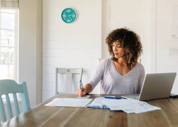 Social Security COLA update planning with notebook and statement